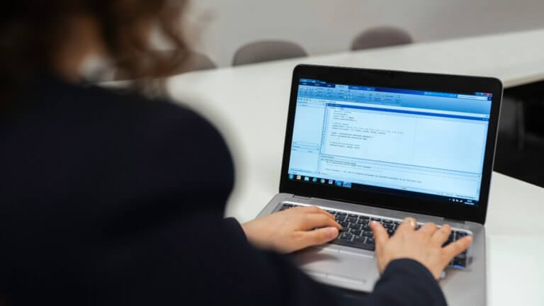 Image of a person typing on a laptop