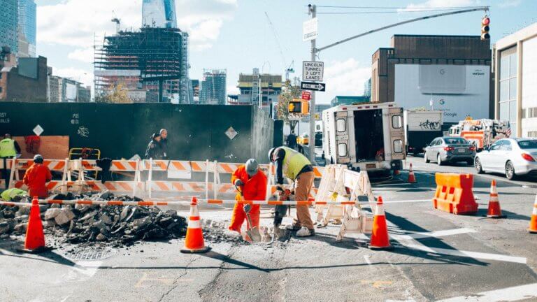 Photo of contractors and subcontractors on site working.